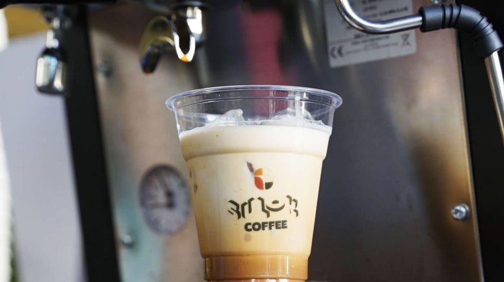 Sulok Coffee iced latte next to espresso machine