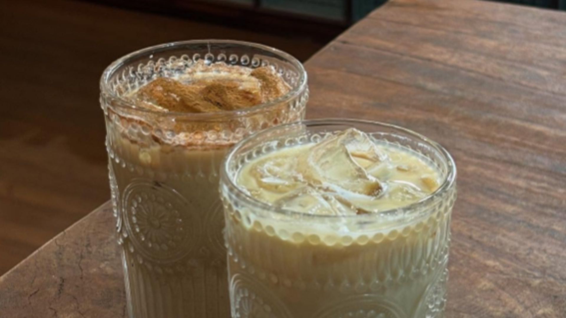 Iced coffee cup in hand with retro interior decor